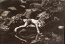 Image of Untitled (boy reaching into lake, mirrored in reflection), from the "Silver Lake" series